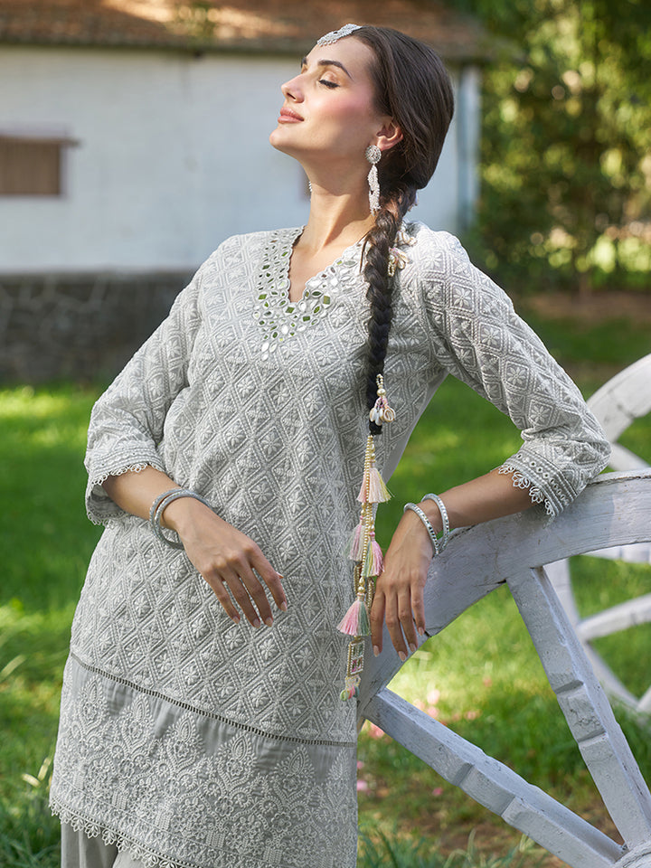 Designed in shimmer georgette, this co-ord set features intricate schiffli embroidery. Shop Now!