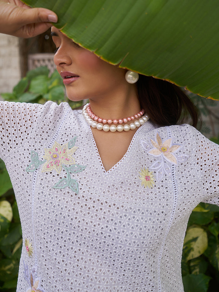 This V-neck co-ord set features delicate floral surface ornamentation for a graceful look. Shop Now!